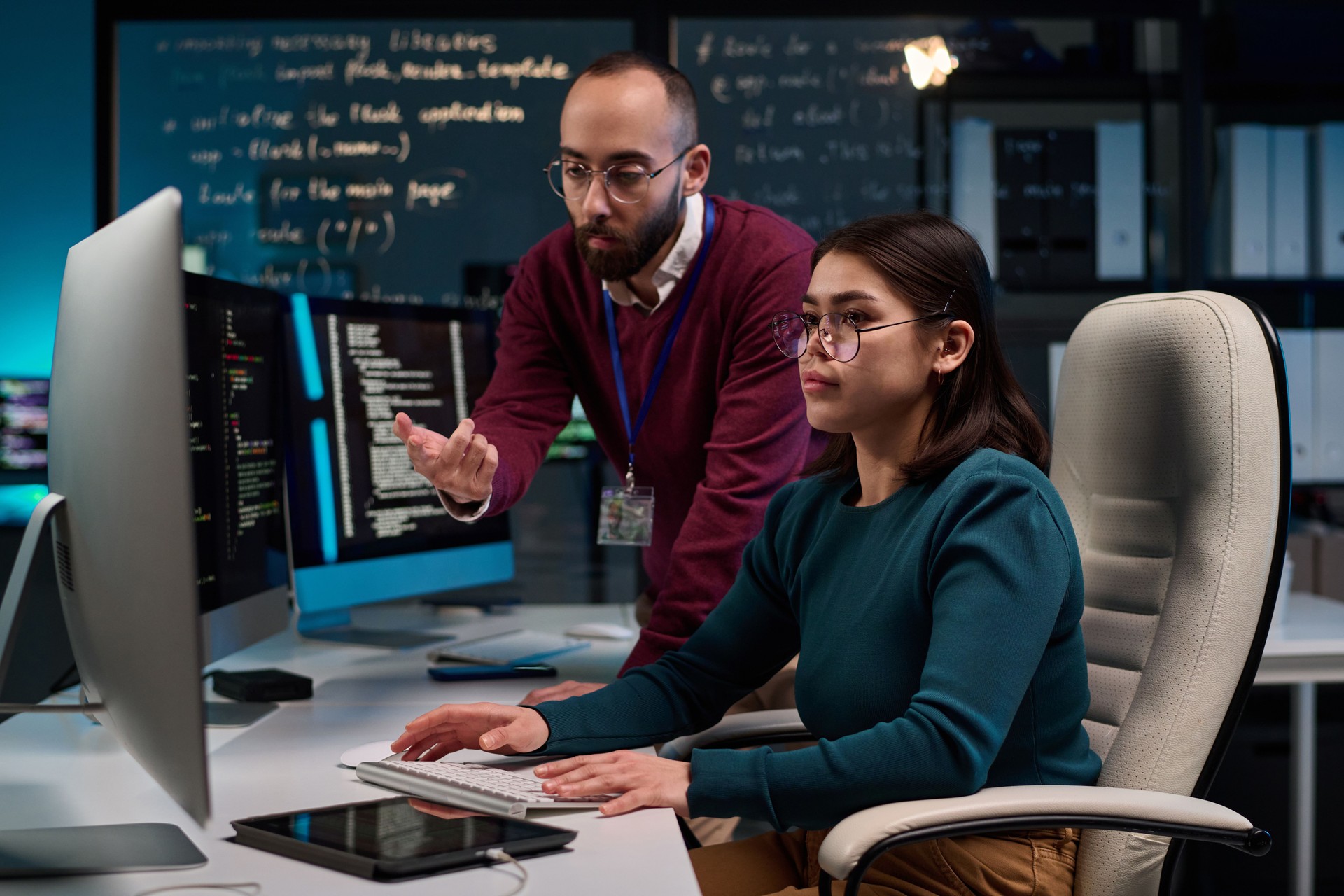 Girl using Computer with Mentor Giving Advice